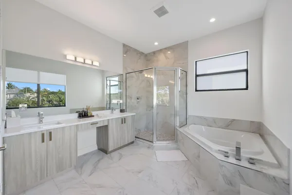 a bathroom with a double vanity sink mirror and double