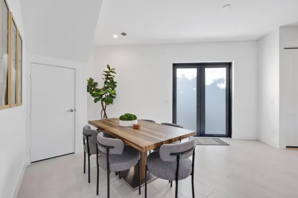 a dining room with furniture and window