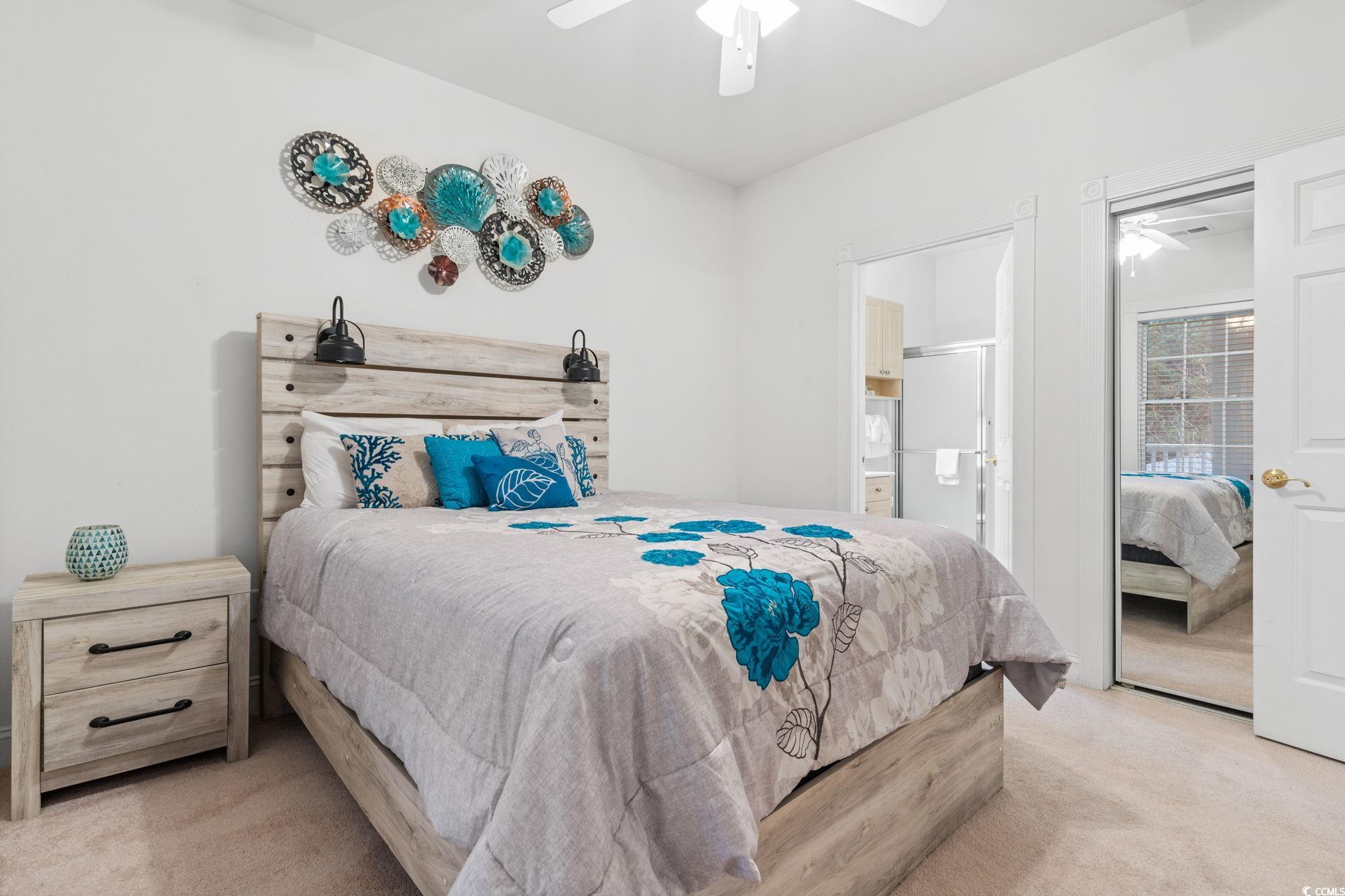 4843 Luster Leaf Circle, Unit 204 Myrtle Beach, SC 29577 - Photo 13 of 36 Bedroom featuring carpet, ceiling fan, and connected bathroom