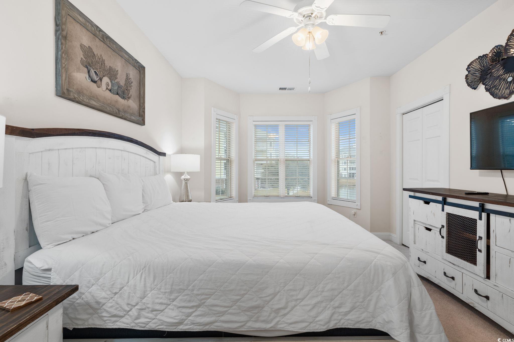 4843 Luster Leaf Circle, Unit 204 Myrtle Beach, SC 29577 - Photo 17 of 36 Bedroom featuring carpet floors and ceiling fan