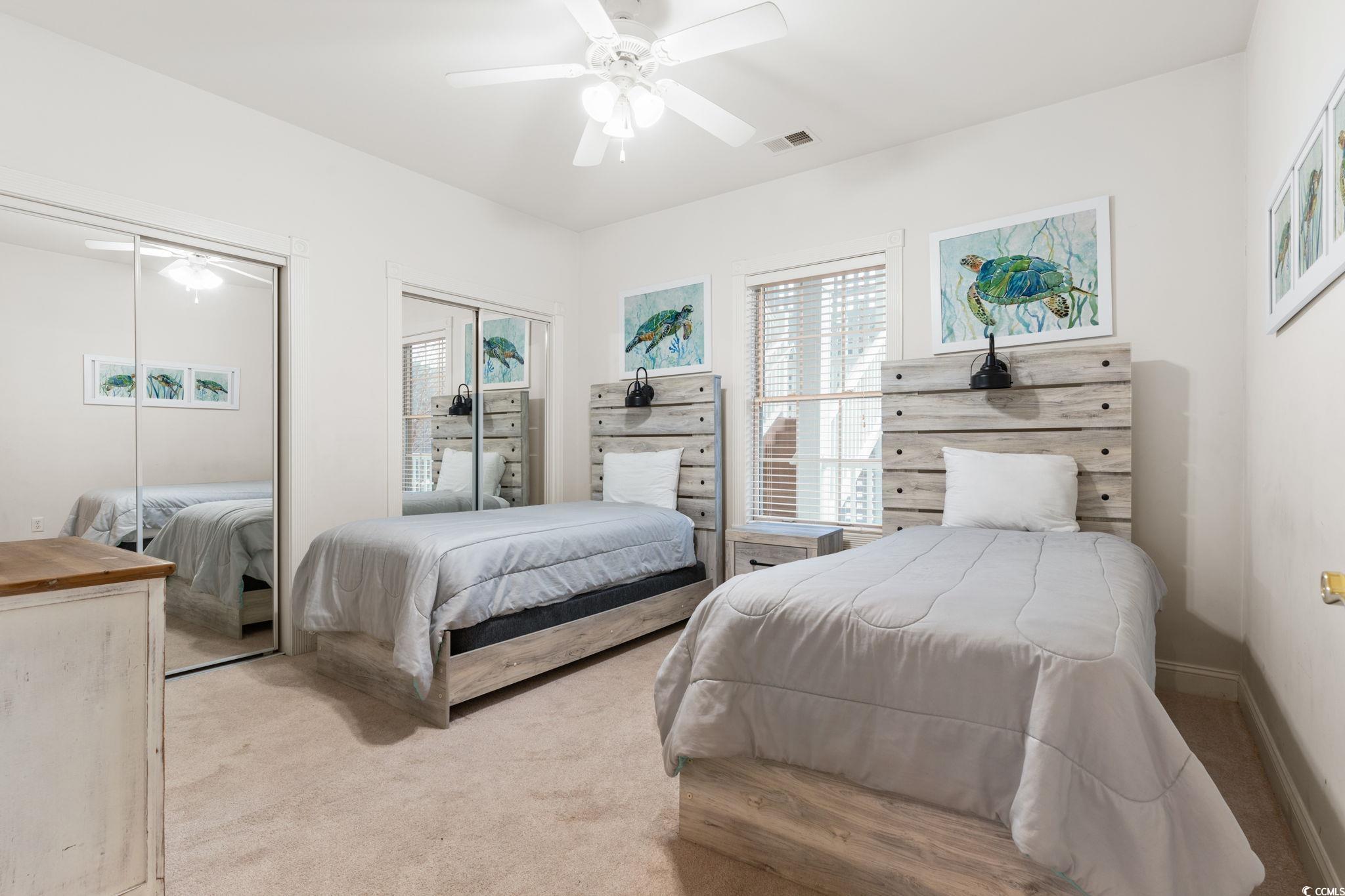4843 Luster Leaf Circle, Unit 204 Myrtle Beach, SC 29577 - Photo 23 of 36 Carpeted bedroom featuring multiple closets and ceiling fan