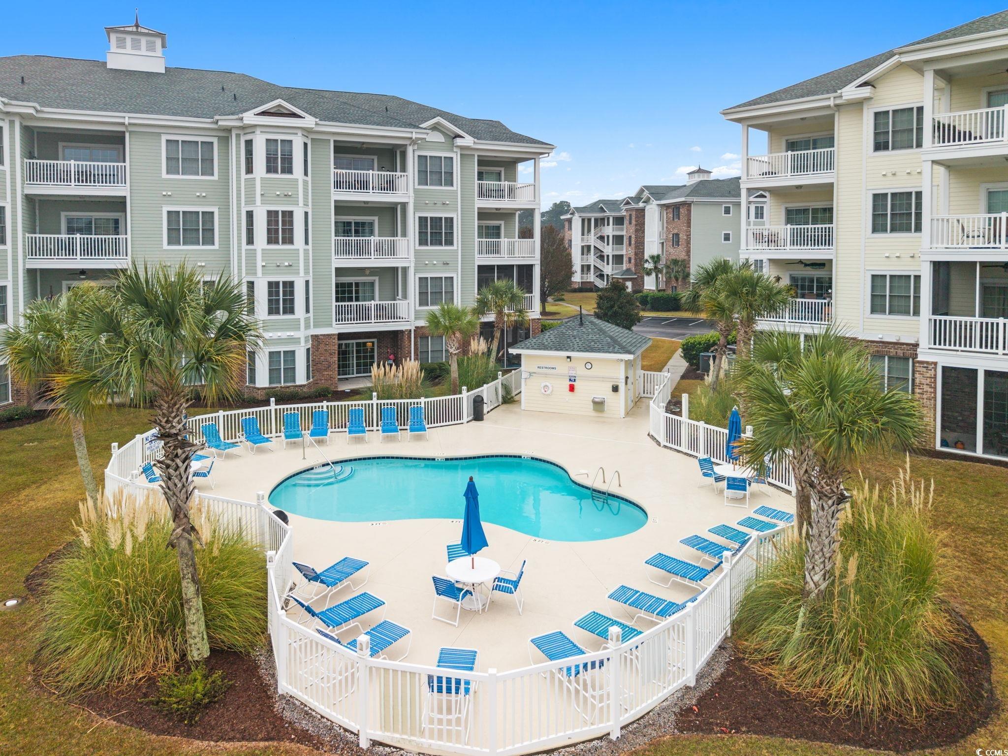 4843 Luster Leaf Circle, Unit 204 Myrtle Beach, SC 29577 - Photo 26 of 36 Community pool with a patio
