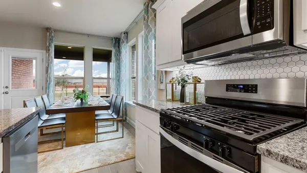 a kitchen with center island a sink appliances and living room view