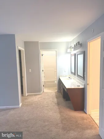 a bathroom with a granite countertop sink and mirror