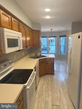 a kitchen with a stove a sink and a microwave