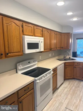 a kitchen with a stove microwave and sink