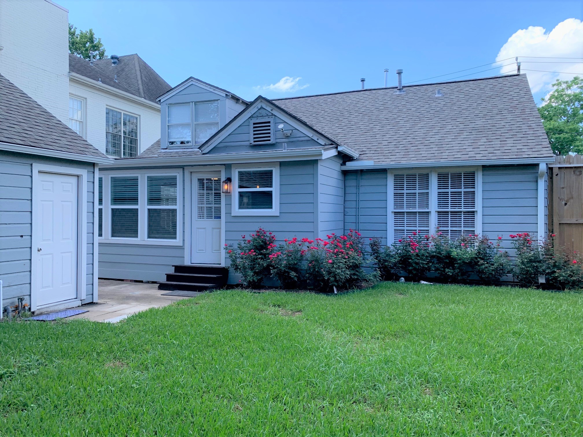 3909 Rice Boulevard Houston, TX 77005 - Photo 17 of 17 a front view of a house with a garden and yard