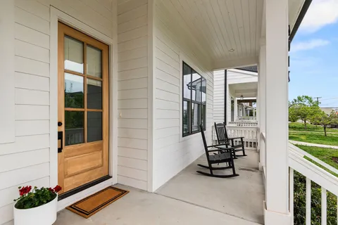 a view of a hallway with wooden floor and entryway
