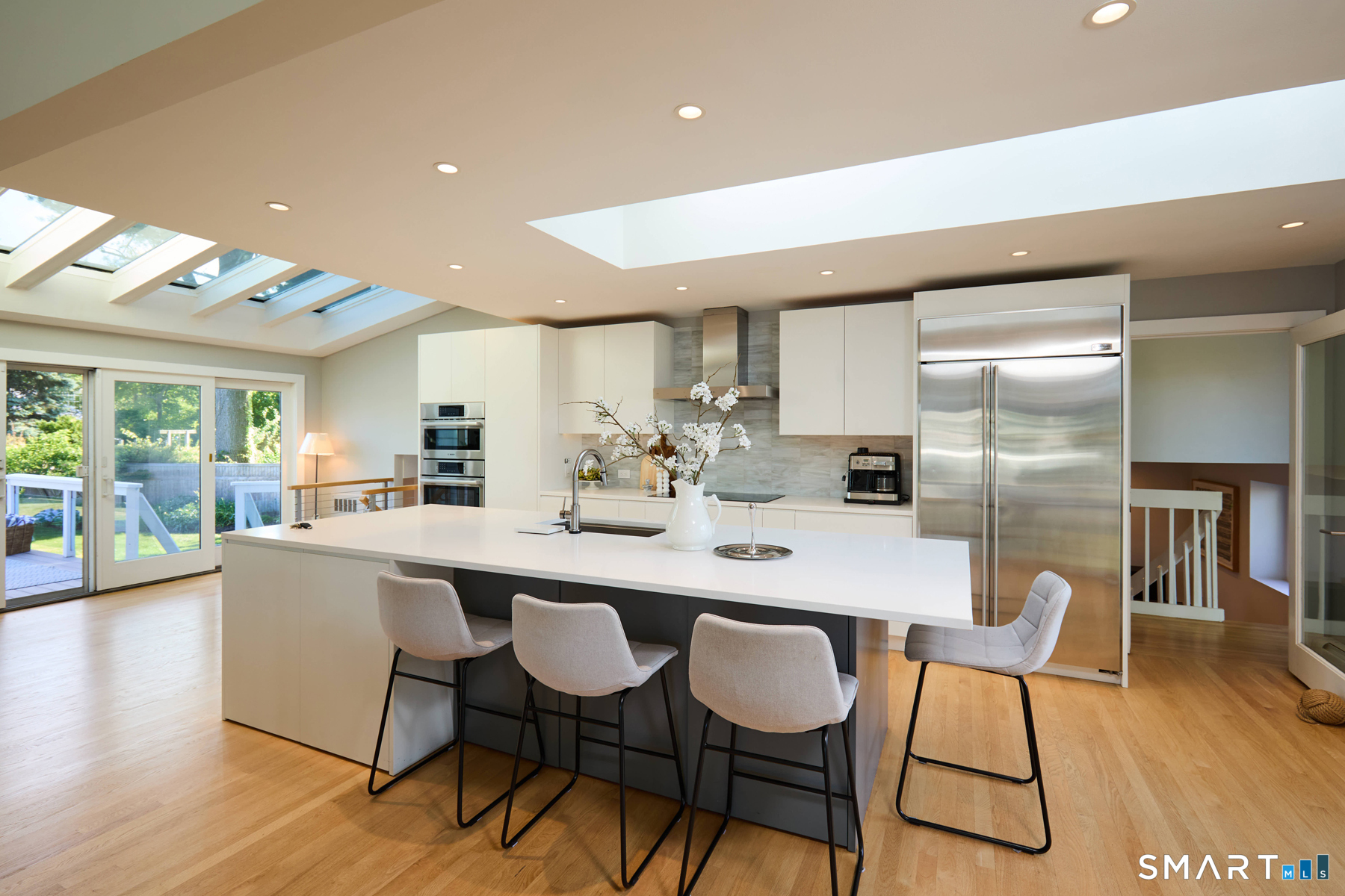 16 Harbor Road Westport, CT 06880 - Photo 11 of 36 a kitchen with a dining table chairs and wooden floor