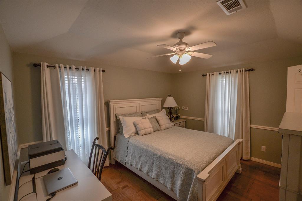 13612 County Road 3900 Athens, TX 75752 - Photo 19 of 40 a bedroom with a bed and a chandelier