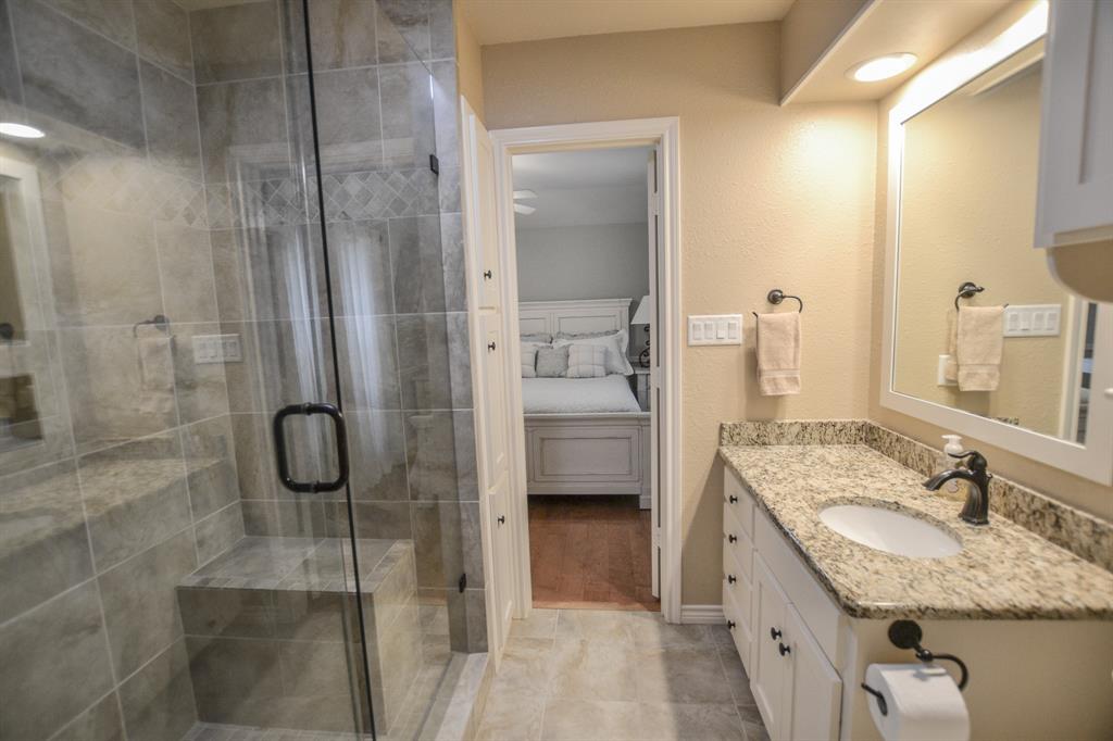 13612 County Road 3900 Athens, TX 75752 - Photo 20 of 40 a bathroom with a granite countertop shower mirror and a sink
