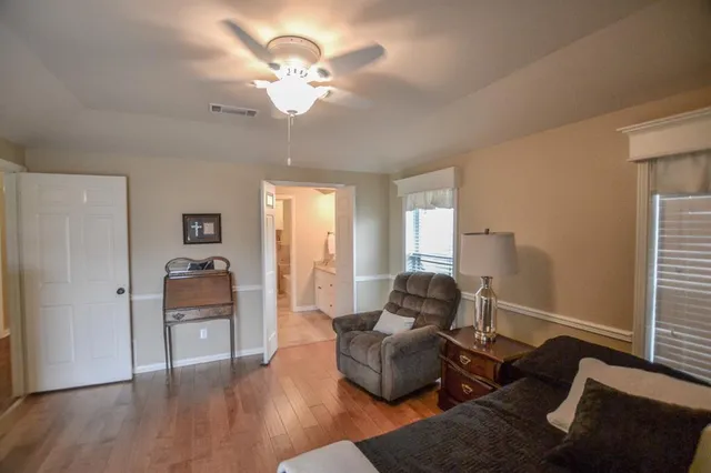 a living room with furniture and wooden floor