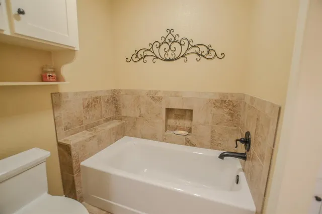 a bathroom with a bathtub and shower