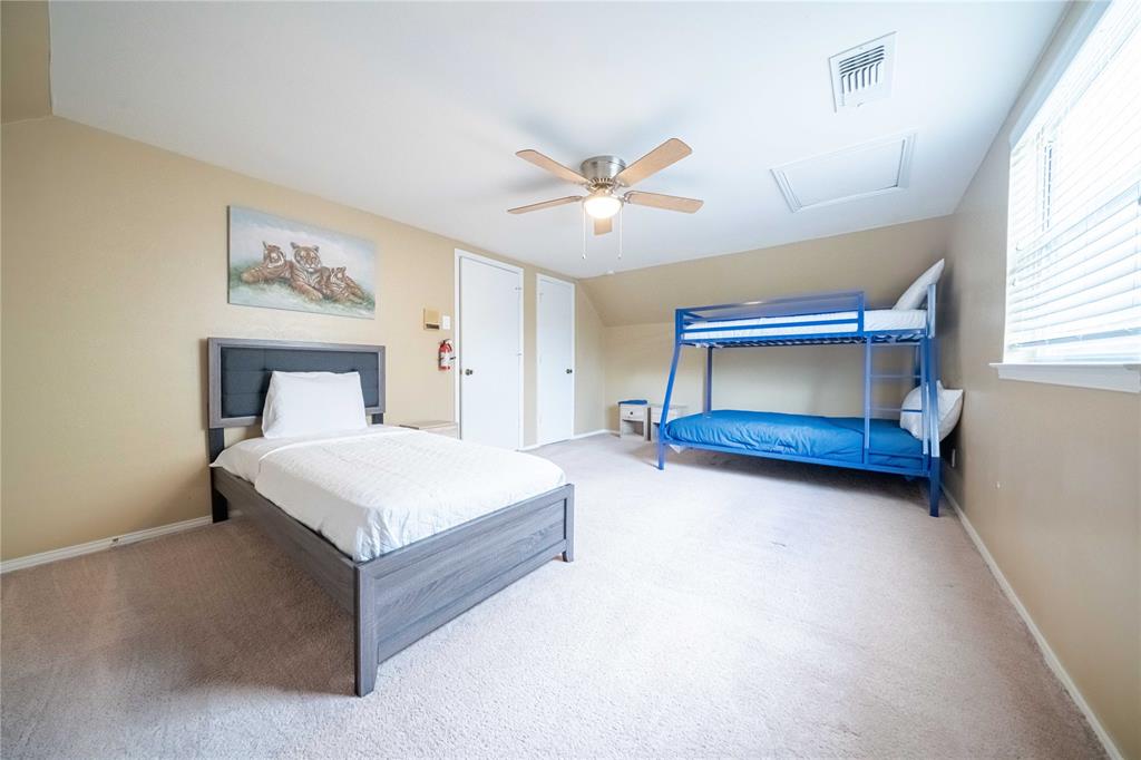 919 Green Hills Road Duncanville, TX 75137 - Photo 23 of 37 Carpeted bedroom with attic access, vaulted ceiling, ceiling fan, and baseboards