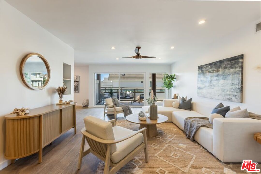 4300 Vía Dolce, Unit 102 Marina del Rey, CA 90292 - Photo 1 of 39 a living room with fireplace furniture and a large window