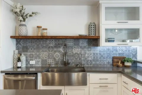 a kitchen with a sink and cabinets