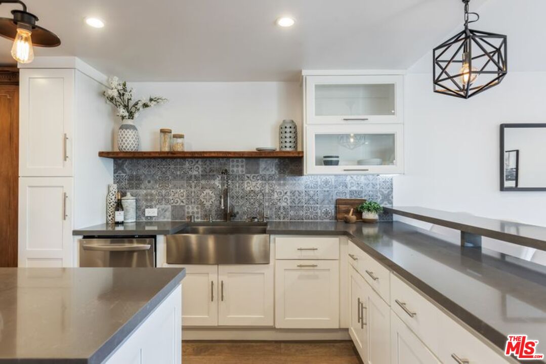 4300 Vía Dolce, Unit 102 Marina del Rey, CA 90292 - Photo 19 of 39 a kitchen with stainless steel appliances granite countertop a sink a stove and cabinets