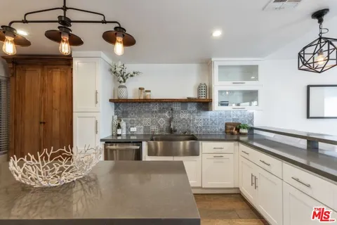 a kitchen with a cabinets and chandelier