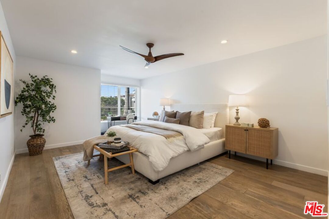 4300 Vía Dolce, Unit 102 Marina del Rey, CA 90292 - Photo 21 of 39 a spacious bedroom with a bed and a potted plant