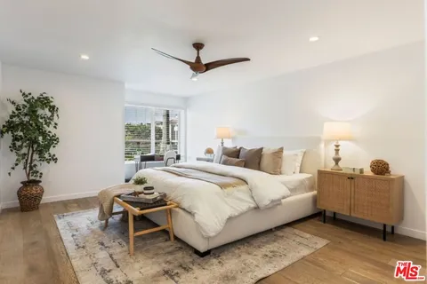 a bedroom with a bed and a potted plant