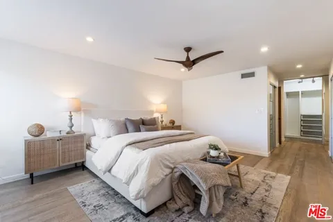 a bedroom with bed and a chandelier