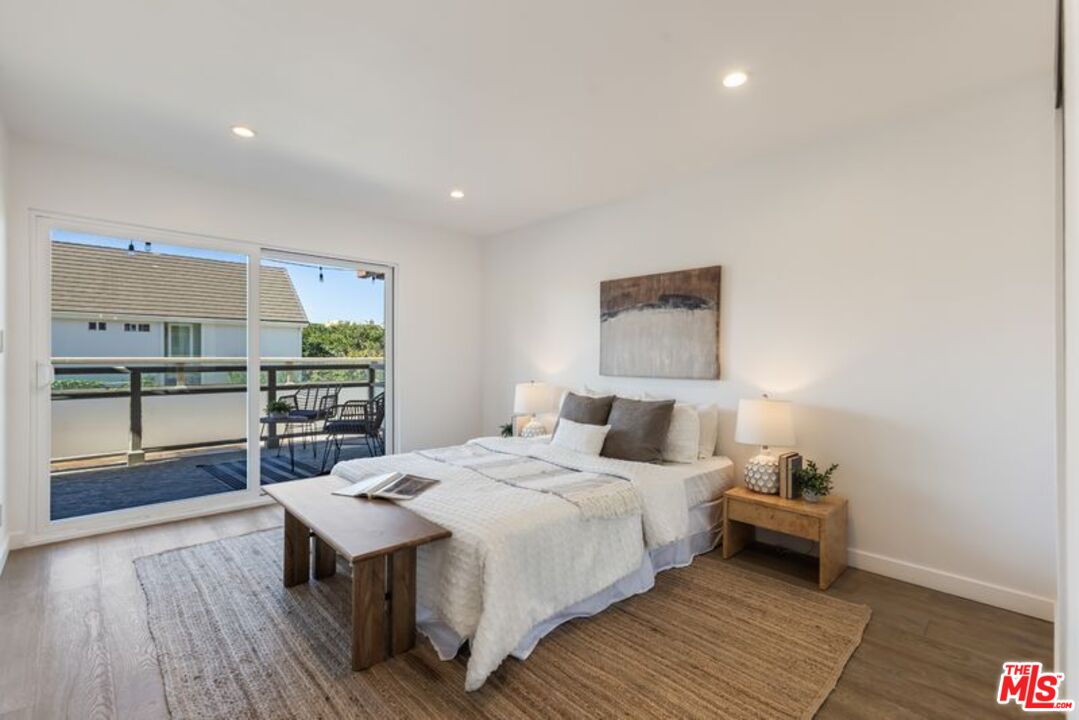 4300 Vía Dolce, Unit 102 Marina del Rey, CA 90292 - Photo 30 of 39 a bedroom with a bed and a view of kitchen