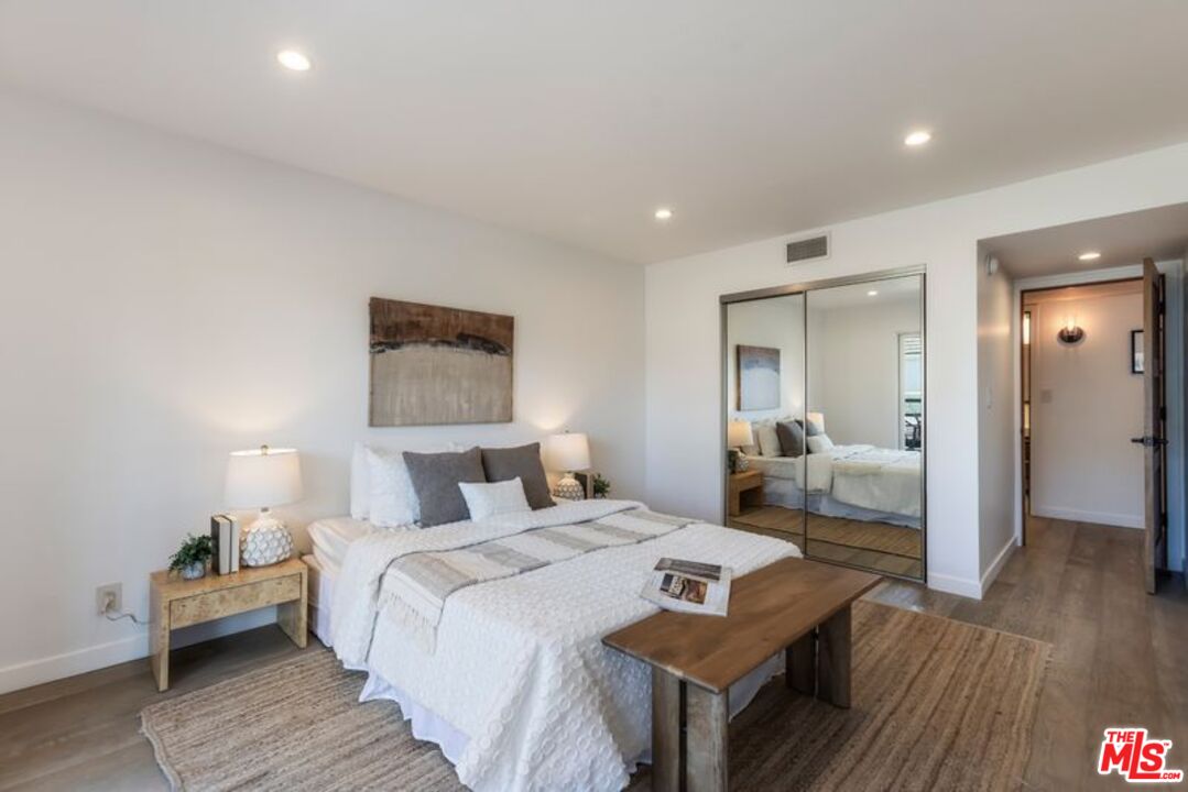 4300 Vía Dolce, Unit 102 Marina del Rey, CA 90292 - Photo 31 of 39 a bedroom with a bed and wooden floor