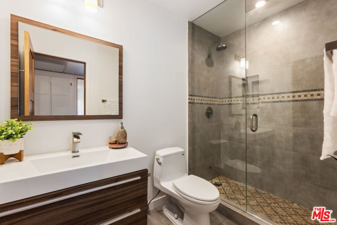 4300 Vía Dolce, Unit 102 Marina del Rey, CA 90292 - Photo 33 of 39 a bathroom with a sink a toilet and shower