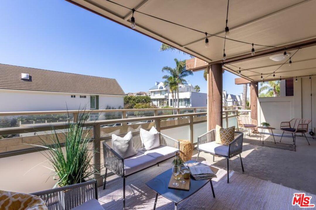 4300 Vía Dolce, Unit 102 Marina del Rey, CA 90292 - Photo 34 of 39 a roof deck with table and chairs