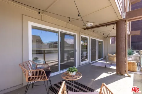 a dining room with furniture a rug and a large window