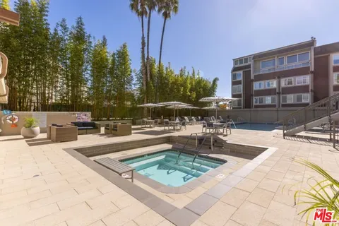 a view of swimming pool with outdoor seating and plants