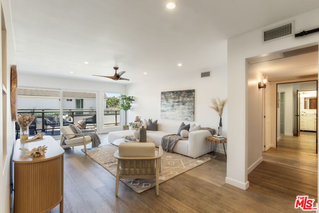 4300 Vía Dolce, Unit 102 Marina del Rey, CA 90292 - Photo 4 of 39 a living room with furniture and wooden floor