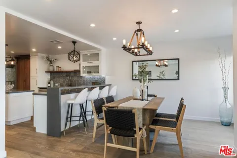 a view of a dining room with furniture and chandelier