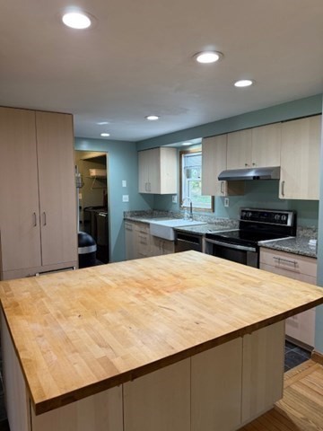 30 Groton Road Shirley, MA 01464 - Photo 7 of 25 a large kitchen with kitchen island granite countertop a stove and a refrigerator
