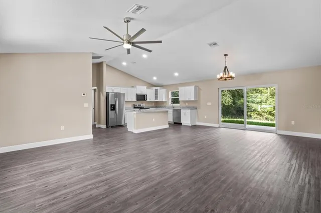 a view of a kitchen with a stove cabinets and wooden floor
