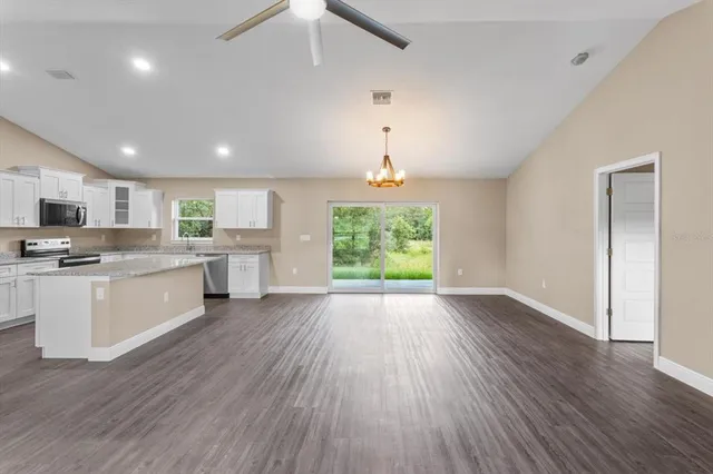 a view of kitchen with wooden floor and electronic appliances