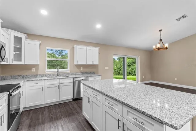 a kitchen with a sink window and cabinets