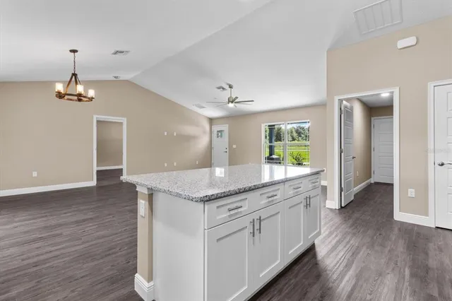 a spacious bathroom with a granite countertop sink a mirror and shower