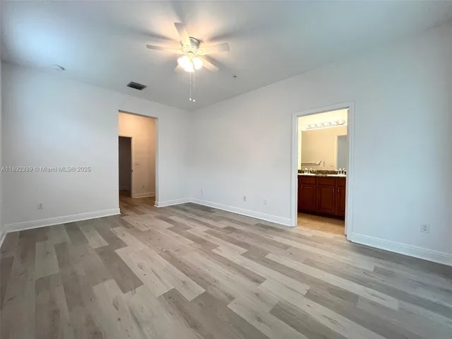 an empty room with a empty space and a ceiling fan