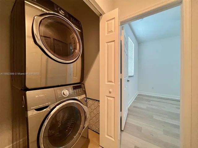 a view of a hallway with washer and dryer
