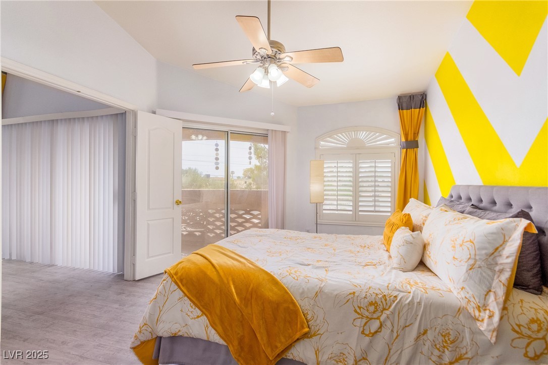 7400 West Flamingo Road, Unit 2006 Las Vegas, NV 89147 - Photo 18 of 30 Bedroom featuring access to outside, wood finished floors, ceiling fan, and vaulted ceiling