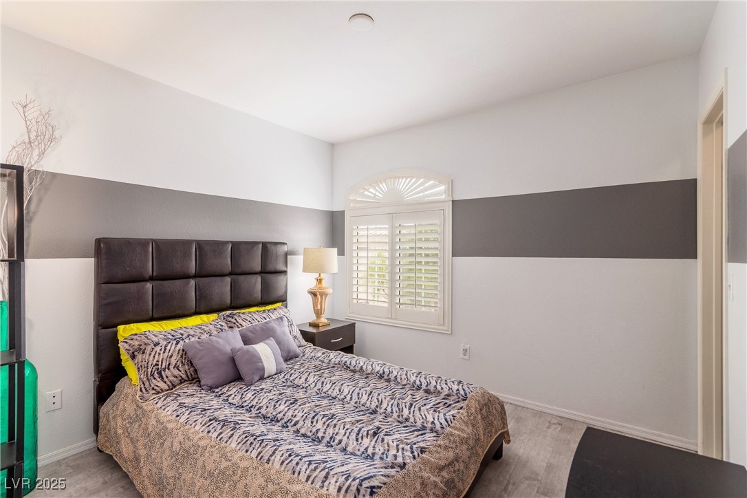 7400 West Flamingo Road, Unit 2006 Las Vegas, NV 89147 - Photo 24 of 30 Bedroom with wood finished floors and baseboards