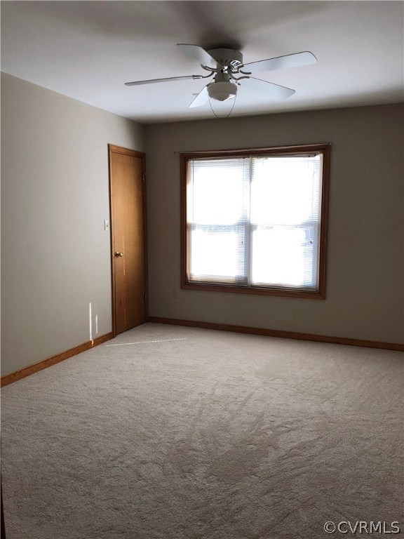 7721 Deer Run Road New Kent, VA 23124 - Photo 11 of 22 an empty room with a window and a ceiling fan