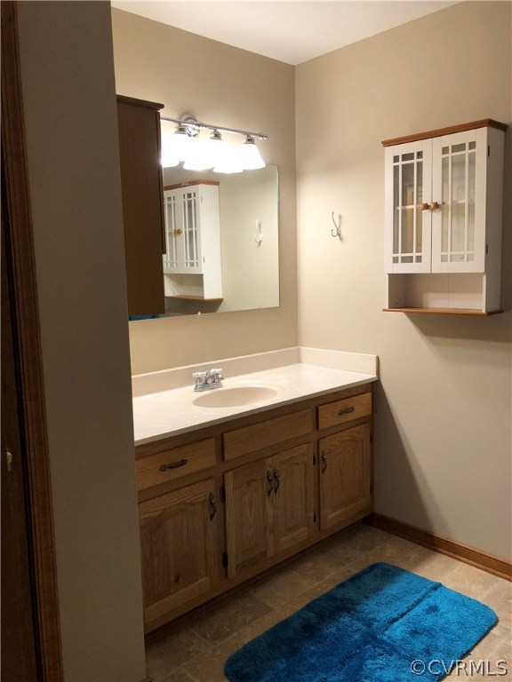 7721 Deer Run Road New Kent, VA 23124 - Photo 18 of 22 a spacious bathroom with a double vanity sink and a mirror