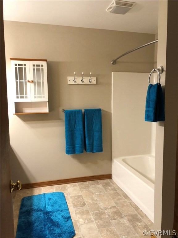 7721 Deer Run Road New Kent, VA 23124 - Photo 19 of 22 a bathroom with a tub and a shower