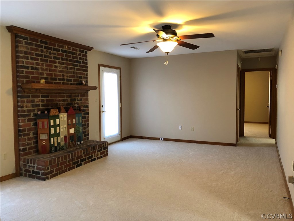 7721 Deer Run Road New Kent, VA 23124 - Photo 4 of 22 a view of a livingroom with a fireplace