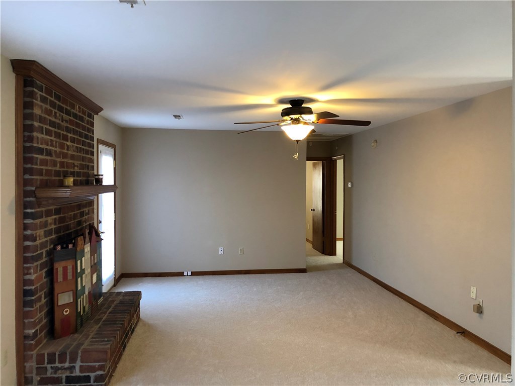 7721 Deer Run Road New Kent, VA 23124 - Photo 6 of 22 a view of entryway and hall with a fireplace