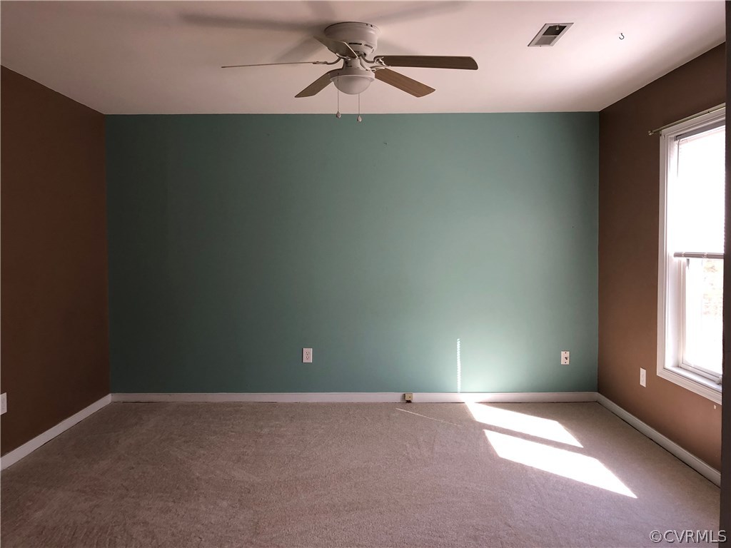 7721 Deer Run Road New Kent, VA 23124 - Photo 7 of 22 an empty room with windows and chandelier fan