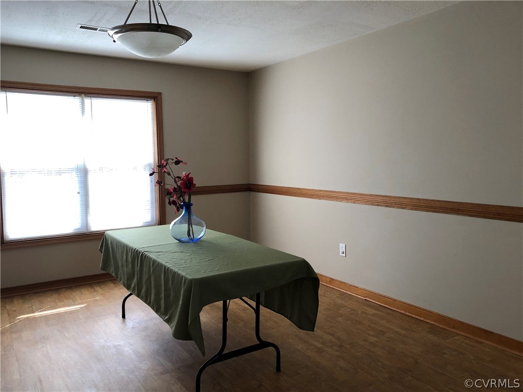 7721 Deer Run Road New Kent, VA 23124 - Photo 8 of 22 a dining room with table and chairs