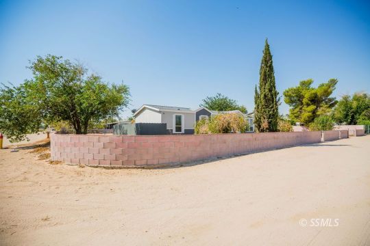 1577 North Calvert Boulevard Ridgecrest, CA 93555 - Photo 4 of 35 a view of a dry yard with a house
